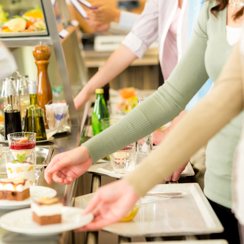 Desserts at cafeteria people with serving tray self service canteen