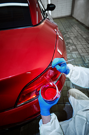 Professional painting of a red car on the service