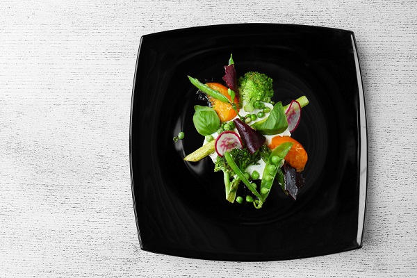 Grilled vegetable salad on black plate