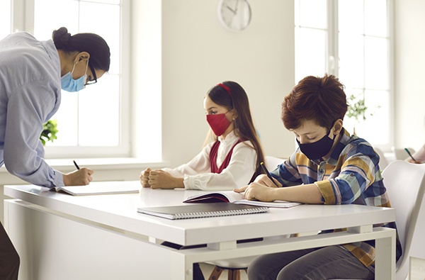 Teachers and students should wear protective masks in school lessons to prevent the spread of coronavirus infection. Concept of the educational process during an outbreak of infectious diseases