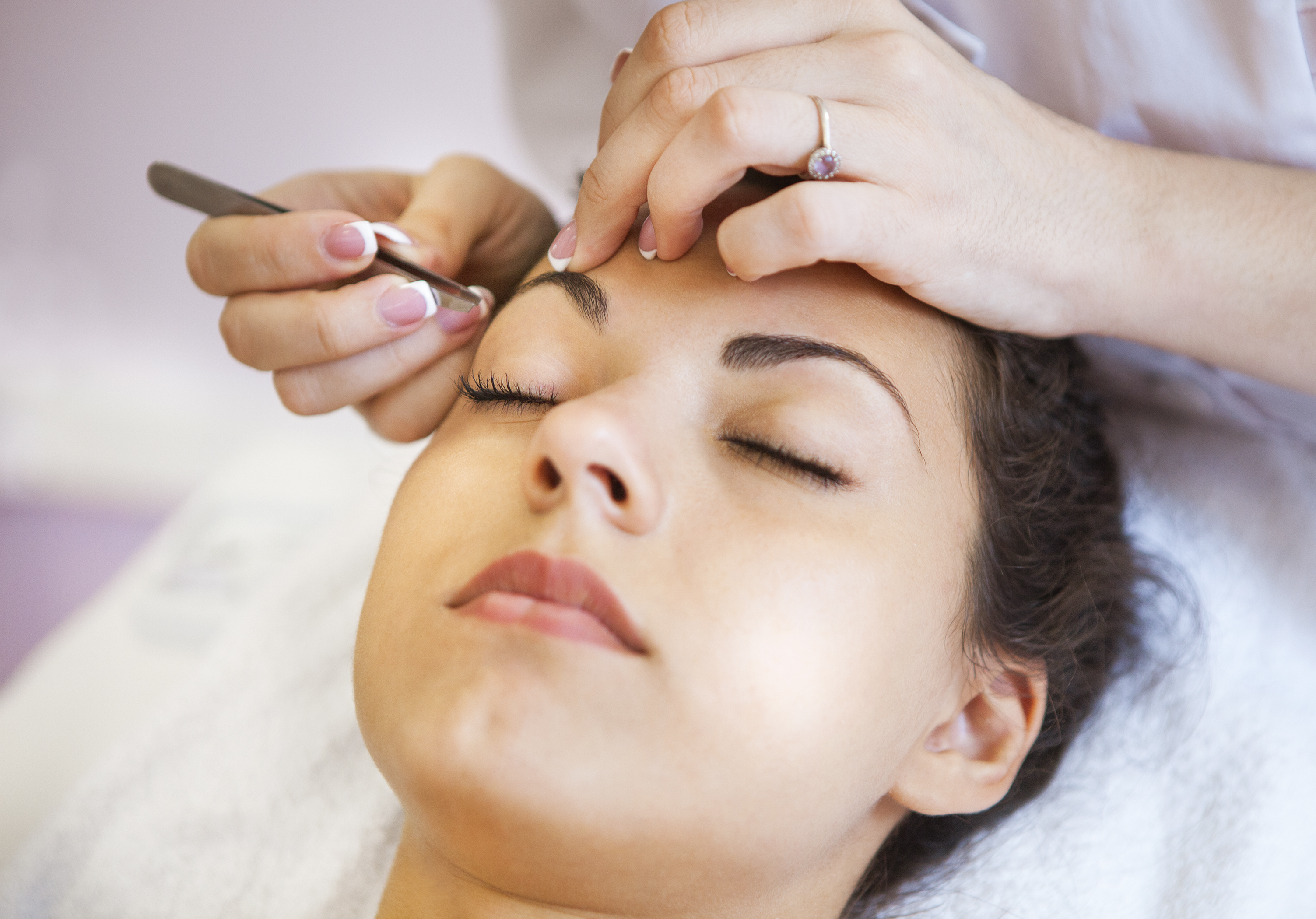 Portrait of a beautiful young woman in cosmetic salon. Close up. Beauty treatments